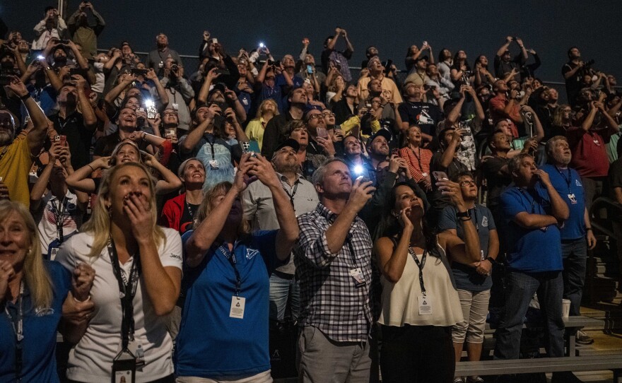 Guests at the Banana Creek watch the launch of NASA's Space Launch System rocket carrying the Orion spacecraft on the Artemis I flight test, early Wednesday, Nov. 16 at NASA's Kennedy Space Center in Fla.