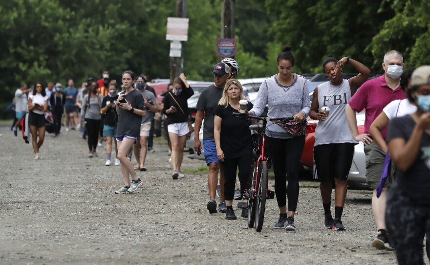 People wait in line to vote in Georgia's June 9 primary election at Park Tavern in Atlanta.