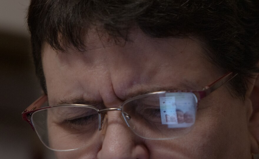 Caregiver Liliya Khodunay responds to messages on the phone during a break in Milan, Italy, in December 2023. For people who experience the conflict from afar, this "social" experience is much more amplified. Phones are not only a way to stay in touch but also to stay constantly updated on the news. The phone affects their mood, doesn't let them sleep at night and rings all the time.