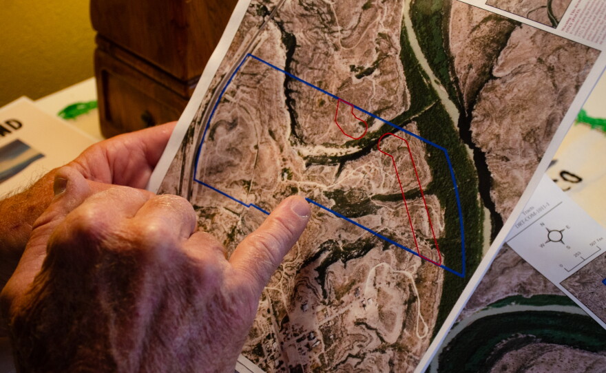 Raymond Skiles holds the letter with a map he received from U.S. Customs and Border Protection earlier this year. It shows the proposed path the border wall would take through his family land in Langtry, Texas.