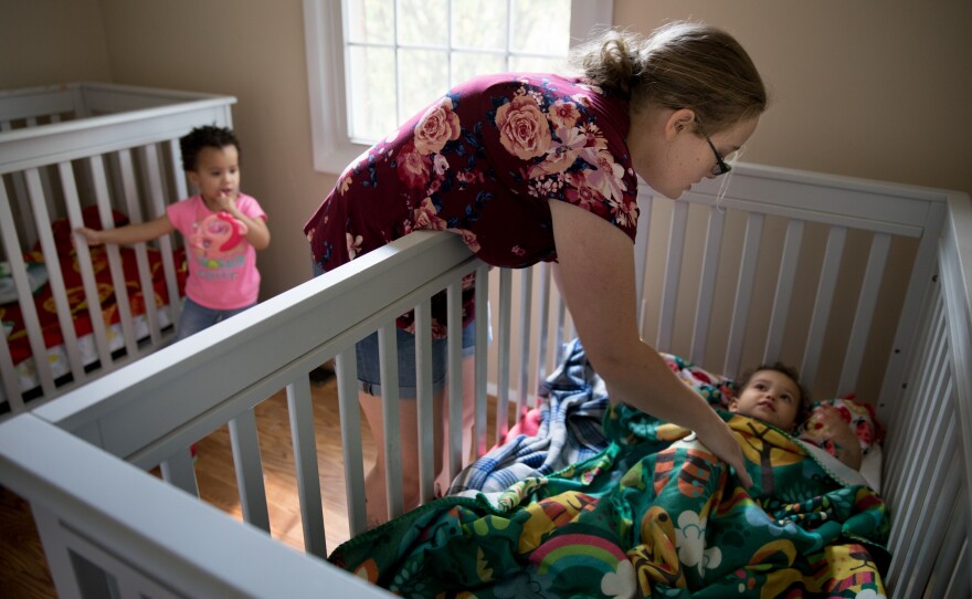Mahoney puts down daughters Jean (left) and Tricia for a nap on Aug. 18.