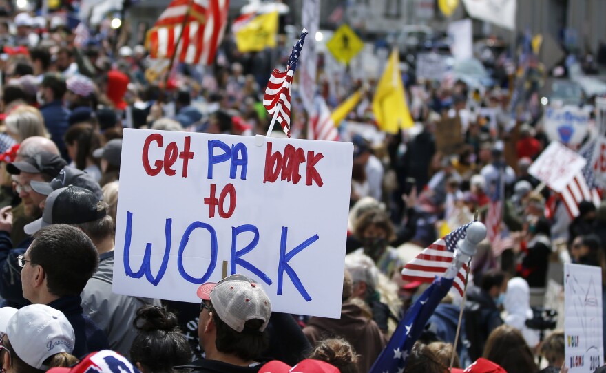 Protesters demonstrate at the state capitol in Harrisburg, Pa., Monday, demanding that Gov. Tom Wolf reopen Pennsylvania's economy even as new social-distancing mandates took effect at stores and other commercial buildings.
