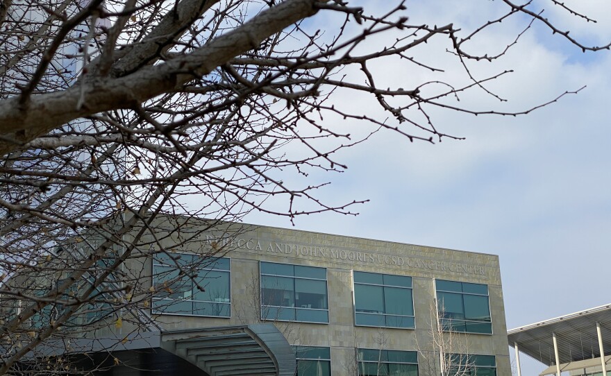 Bare branches sit in the foreground of the UC San Diego's Moores Cancer Center, Jan. 16, 2020.