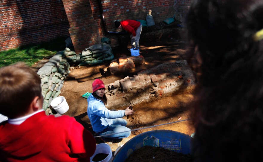 Archaeologists excavate a section of the fort near a church tower that was built in the 17th century.