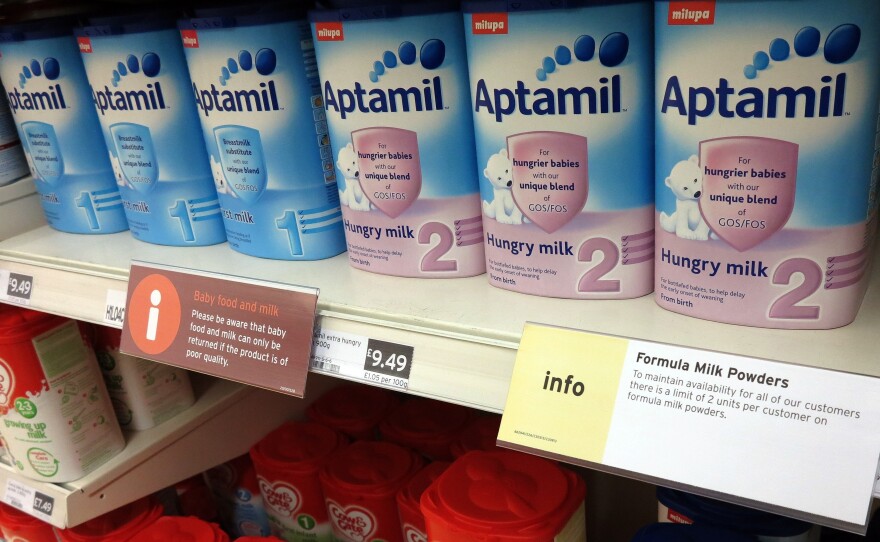 A sign limiting the purchase of baby formula powder hangs on a shelf in a London supermarket April 10.