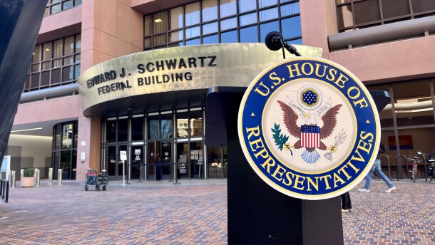 A podium for with a U.S. House of Representatives emblem stands in front of the Edward J. Schwartz Federal Building in downtown San Diego, Oct. 20, 2025.
