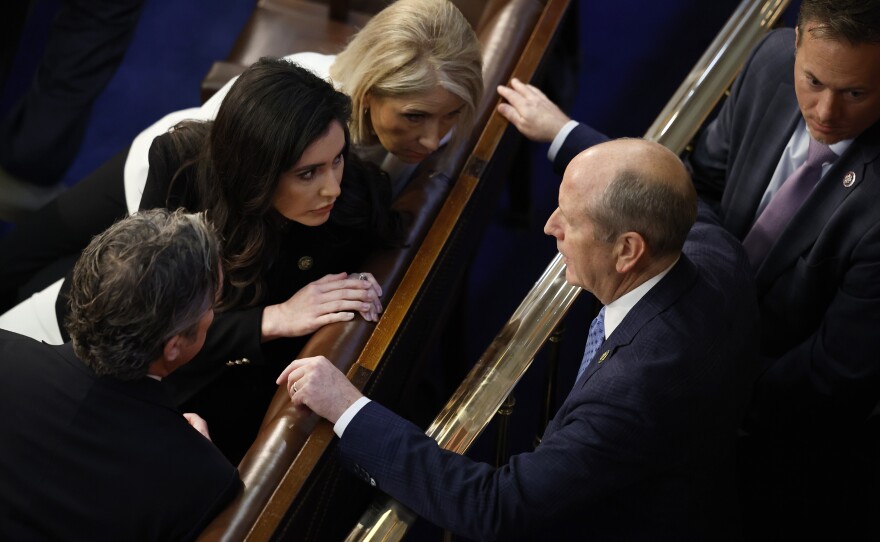 Rep.-elect Dan Bishop (R-NC), right, tells fellow members, including Rep.-elect Anna Luna (R-FL) and Rep.-elect Mary Miller (R-IL), that he will support Republican Leader Kevin McCarthy (R-CA) in that round of voting for Speaker of the House.