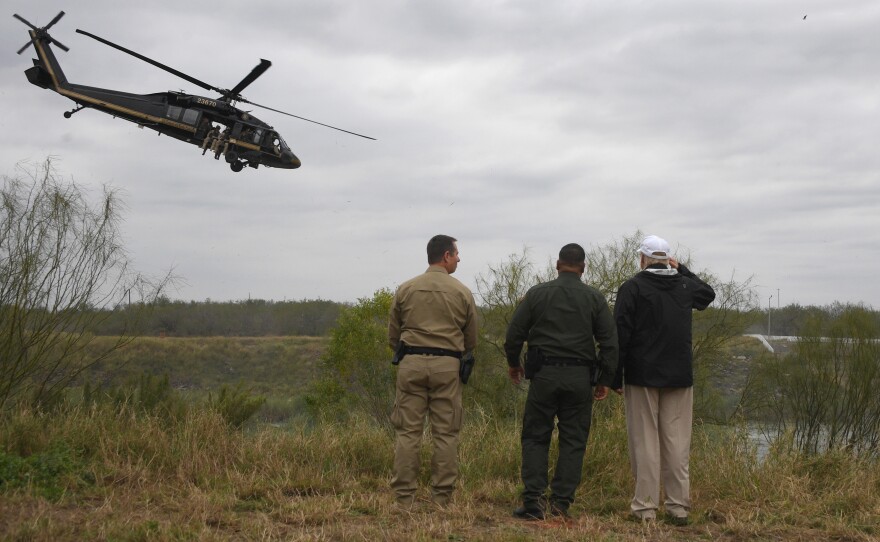 President Trump with Border Patrol agents at the Rio Grande as a Customs and Border Protection helicopter flies over near McAllen, Tex., on Jan. 10, 2019.