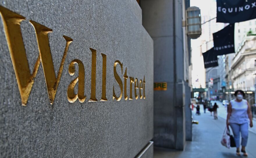 People walk near the New York Stock Exchange on June 29. The S&P 500 index has fully recovered from its plunge earlier this year, when pandemic lockdowns began shutting down much of the economy.