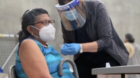 A woman getting vaccinated against COVID-19 at the Border View Family YMCA in Otay Mesa, Feb. 24, 2021.