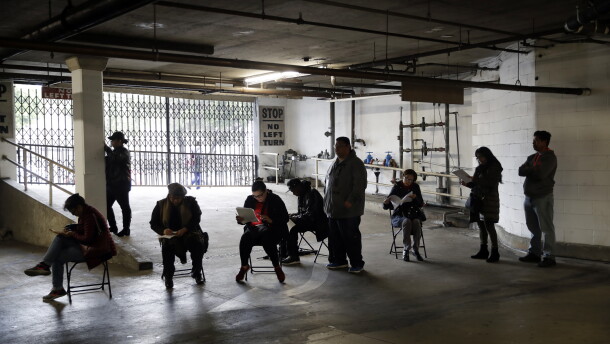 Hospitality workers wait in line to apply for unemployment benefits at the outset of the COVID-19 pandemic in March 2020.