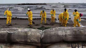 A BP cleanup crew removes oil from a beach on May 23 at Port Fourchon, La.
