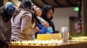 Lidia Steineman, who lost her home in the Camp Fire, prays during a vigil for fire victims on Sunday, Nov. 18, 2018, in Chico, Calif.
