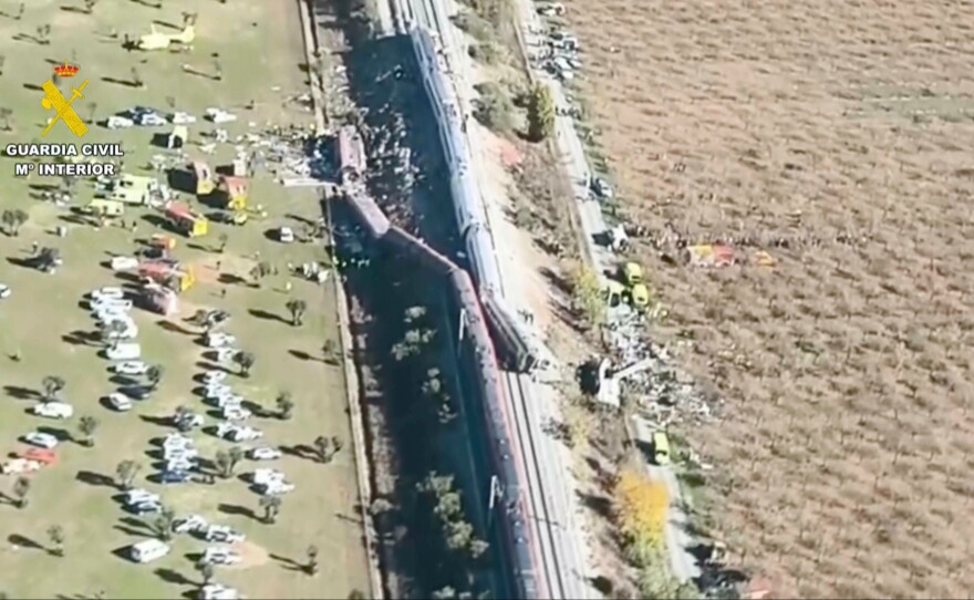This framegrab taken from a video provided by Spain's Guardia Civil shows an aerial view of carriages and first responders on the site of a collision between two trains in Urda, Spain, Wednesday.