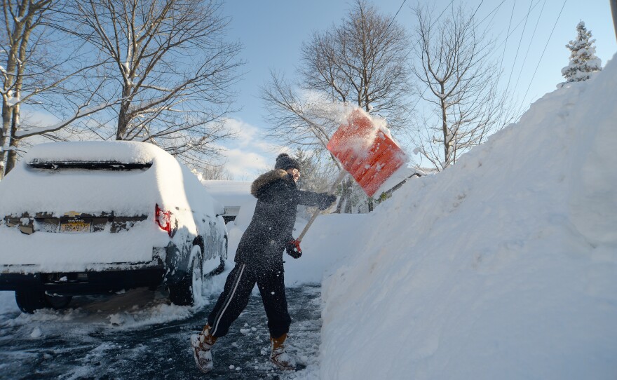 Heather Ahmed digs out after an intense lake-effect snowstorm impacted the Buffalo, New York, area on Saturday.