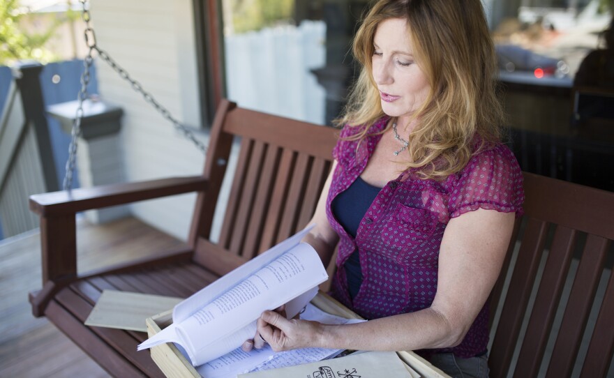 Kadie Durocher looking through memorabilia she collected while working at American Voodoo, a San Diego restaurant, Aug. 22, 2016.