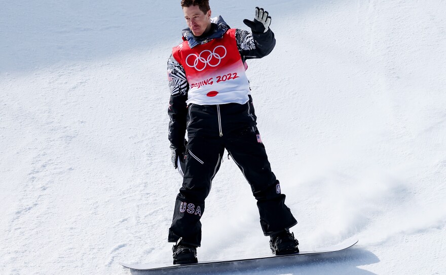 Shaun White of Team USA waves goodbye after his final run in the Men's Snowboard Halfpipe Final at the Beijing 2022 Winter Olympics. He placed fourth in his final race.