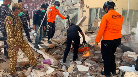In this photo released by the Indonesian National Search and Rescue Agency (BASARNAS), rescuers attempt to clear debris at building damaged by an earthquake in Maumere, East Nusa Tenggara Province, Indonesia, Saturday, Aug. 15, 2026.