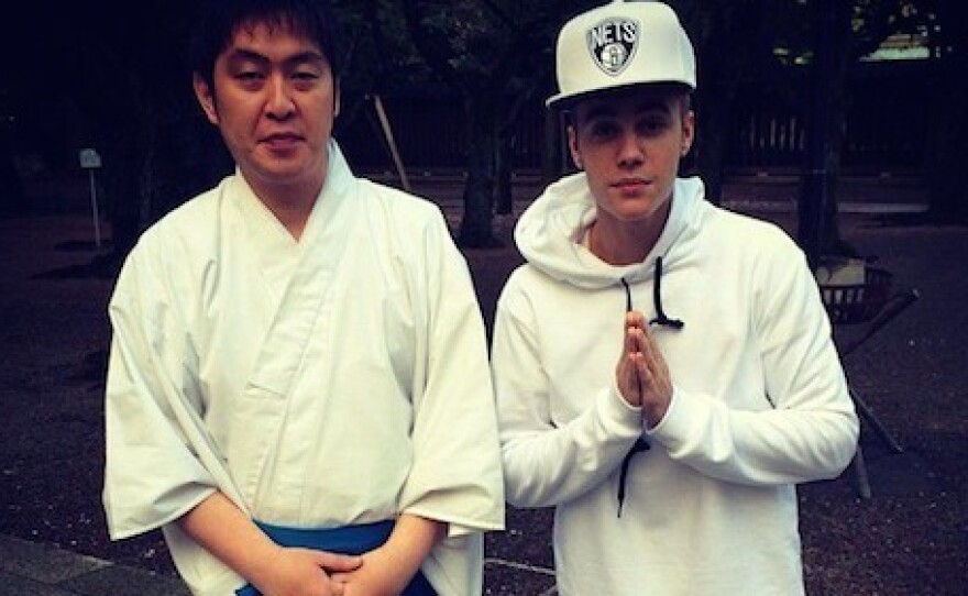 Justin Beiber poses next to unidentified man at Yasukuni Shrine in Tokyo.
