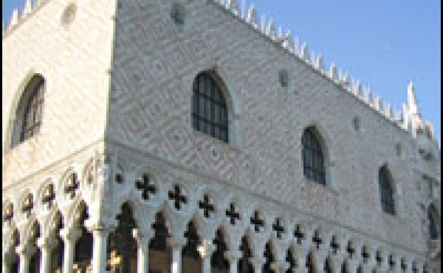 The exhibition is being held in the Doges' Palace. Running along the top, the palace's crenelated decoration exemplifies Eastern influence.
