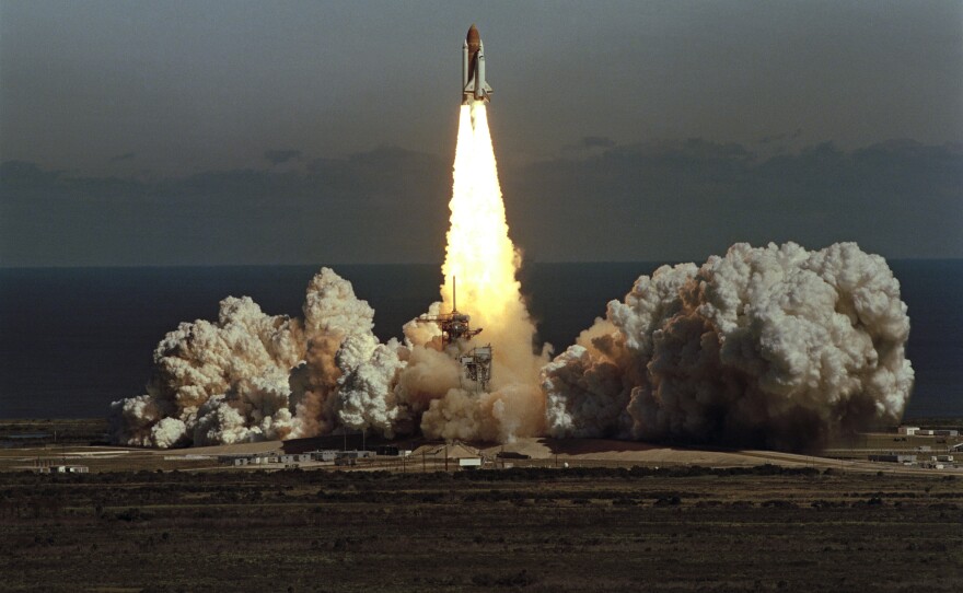 The space shuttle Challenger lifts off from Kennedy Space Center in Florida on Jan. 28, 1986, in a cloud of smoke with a crew of seven aboard. The shuttle exploded shortly after this photo.