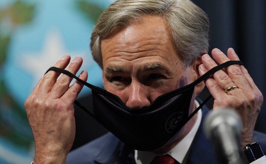 Texas Gov. Greg Abbott, seen here donning a mask in September, announced Tuesday he will lift the state's mask mandate.