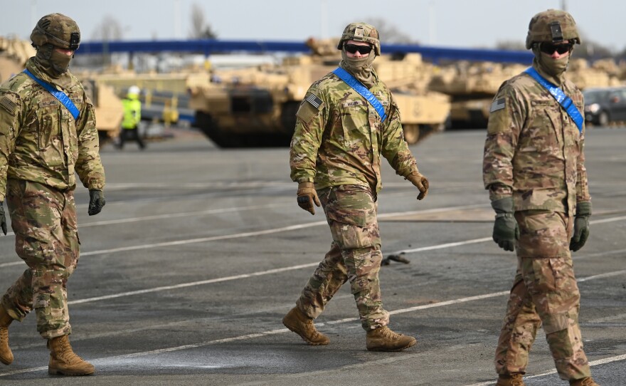 U.S. soldiers walk alongside tanks from the U.S. 2nd Brigade Combat Team, 3rd Infantry Division, parked at Germany's Bremerhaven port on Feb. 21. The U.S. could be considering drawing down a portion of its armed forces based in Germany.