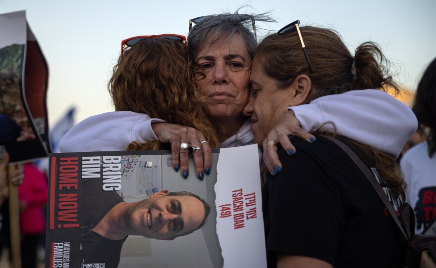 Einat Ofir embraces her cousins, Ronit Dvir and Karni Peleg, after a ceremony at the site of the former police station in Sderot, Israel on Feb. 28. The families of the Israeli hostages held a four-day march to keep attention focused on the plight of their loved ones still in captivity and to pressure the Israeli government to secure a deal that would release them.