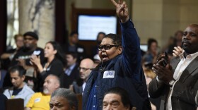 Donnie Anderson, co-founder and chairman of the California Minority Alliance, reacts after the Los Angeles City Council voted unanimously to approve new regulations for the marijuana industry on in Los Angeles. Wednesday, Dec. 6, 2017. 
