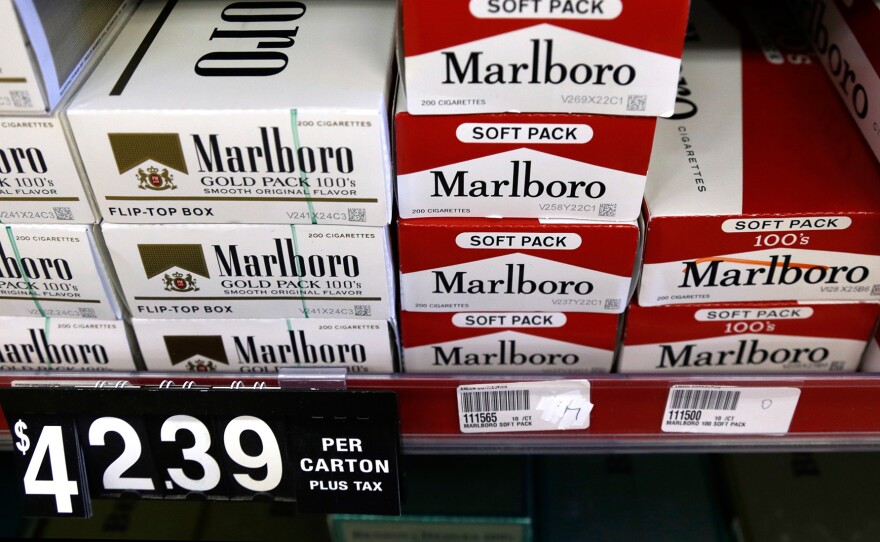 Cartons of cigarettes on shelves at Discount Smoke Shop in Ballwin, Mo., in 2012 were much cheaper than cigarettes in most other states. Missouri's tobacco tax is still only 17 cents per pack, but will rise if either of two state ballot measures passes this month.