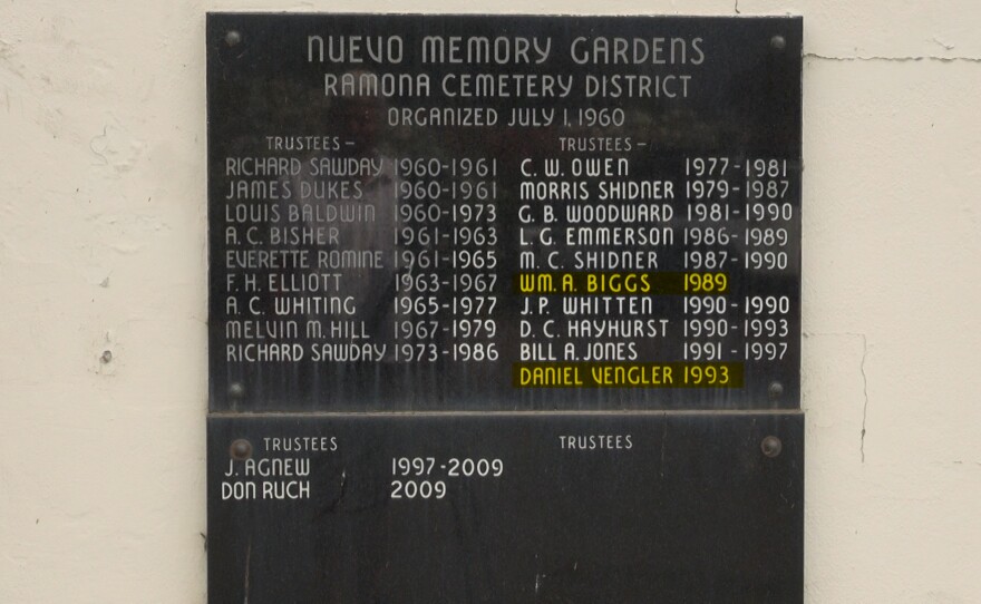 A plaque outside the Nuevo Memory Gardens Cemetery shows the names of Ramona Cemetery District board members over the years.