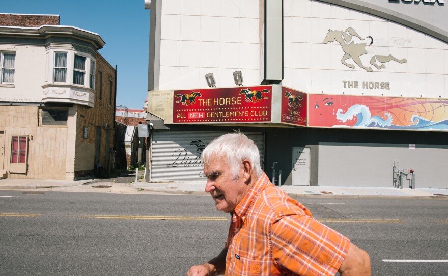 A man walks by The Horse Gentlemen's Club on the south end of the Atlantic City boardwalk.