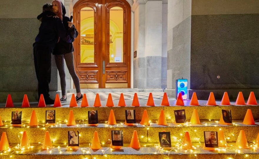 Erika Pringle, at right, embraces Allison Lyman, whose son died in a collision, during a candlelight vigil as part of The World Day of Remembrance for Road Traffic Victims at the Capitol in Sacramento on Nov. 16, 2025.