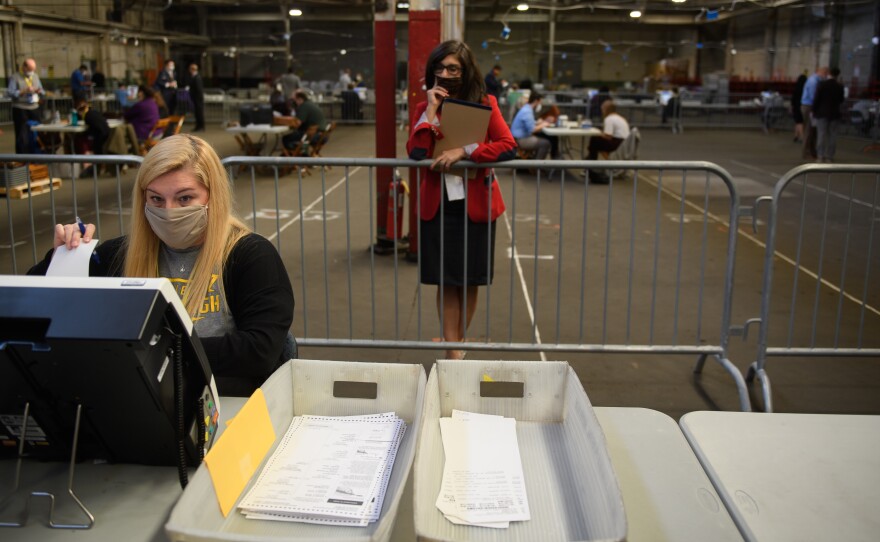 A poll watcher monitors the counting of ballots at the Allegheny County elections warehouse on November 6, 2020 in Pittsburgh.