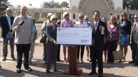 City Council President Todd Gloria and Jason Quinn (far left) of the Balboa Park Online Collaborative pose with a $15,000 check for expanded wireless Internet services in Balboa Park, Aug. 15, 2013. 