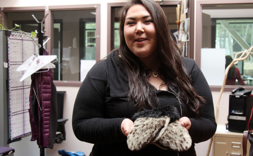 Cordelia Kellie showing off her sealskin gloves, made by a woman from Shishmaref and purchased at a dance festival.