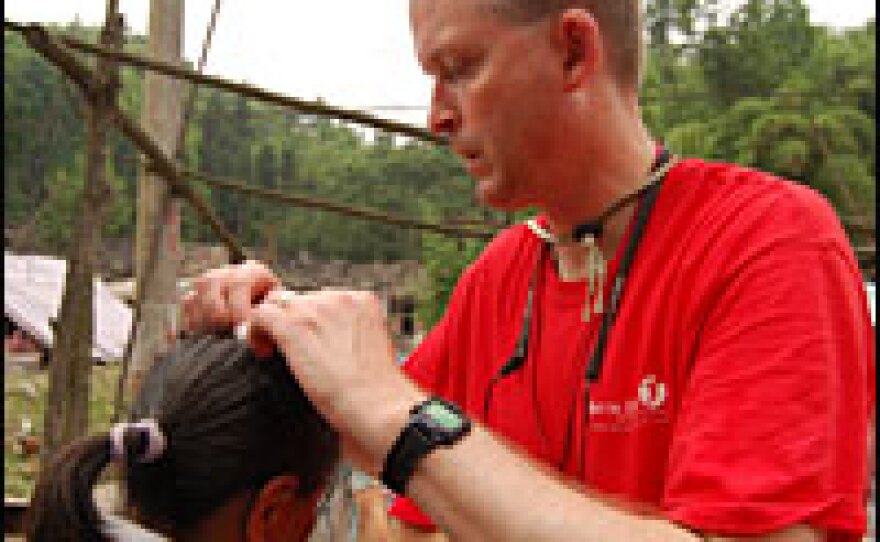 Bill Burke, a family practice doctor, attends minor ailments in a mountain village near Chengdu.