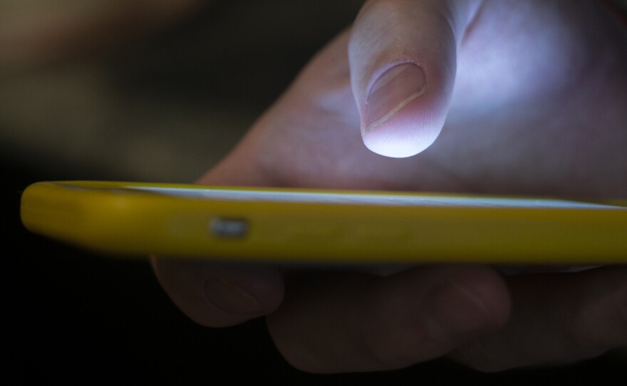 In this Aug. 11, 2019, file photo, a man is using a cell phone. 