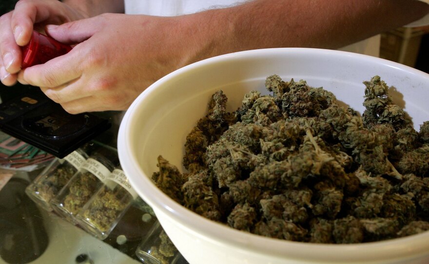 A worker packages medical marijuana in San Francisco in 2006. City prosecutors say they'll clear thousands of marijuana convictions.