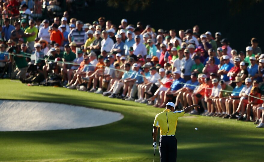 Tiger Woods drops his ball after hitting into the water on the 15th hole during the second round of the Masters Tournament at Augusta National Golf Club. He was later assessed a two-stroke penalty for the improper drop.