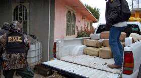 Police unload packages of marijuana confiscated in January in Nuevo Laredo, Mexico. The U.S. Drug Enforcement Administration estimates half of all Mexican marijuana is smuggled into the U.S. through South Texas. Two drug cartels are now fighting for control of the area.
