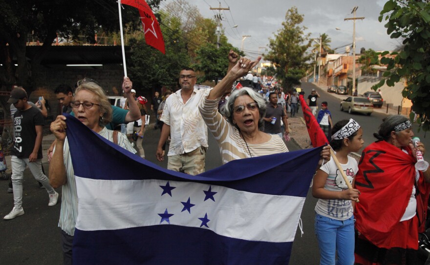Members of the opposition to the administration of Honduran President Juan Orlando Hernandez march on Friday to protest the U.S. government's decision to end the Temporary Protected Status designation for nearly 57,000 people from Honduras. Hernandez called the decision a sovereign issue for Washington, adding that "we deeply lament it."