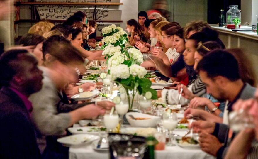 Guests attend a Refugees Welcome dinner at Lapis restaurant in Washington, D.C. The goals of the evening: to bring locals together with refugees in their community and to break barriers by breaking bread.