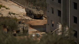 Israeli armored vehicles are seen parked outside a Palestinian building in the West Bank town of Turmus Ayya, Friday, Oct. 23, 2026. (AP Photo/Leo Correa)
