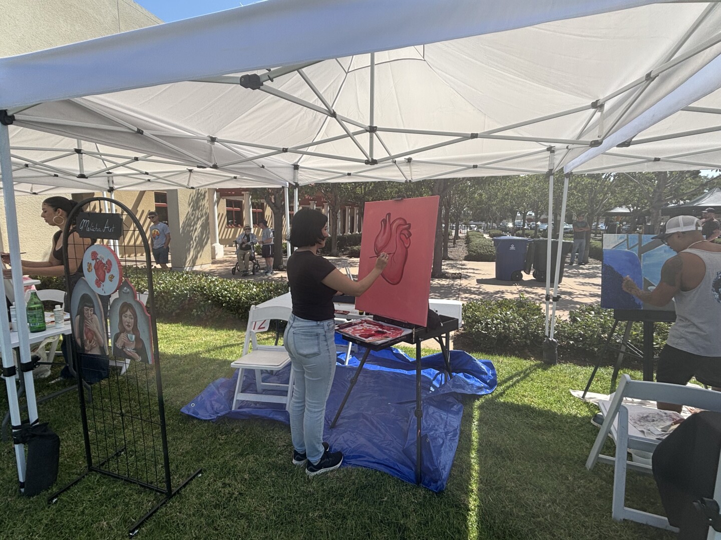 Ariana Arroyo (left), Melissa Salgado (middle), and Vince Alvendia live painting at Chula Vista Art Fest in front of the City Hall on Sept. 27, 2025.