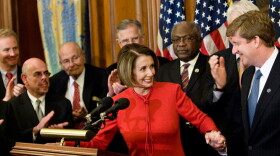 Pelosi takes Rep. Patrick Kennedy's hand at a news conference at the U.S. Capitol on Saturday.