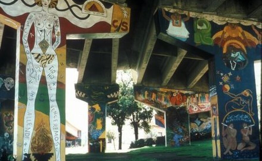 Image of Chicano Park murals painted on concrete pillars which support the Coronado Bridge.