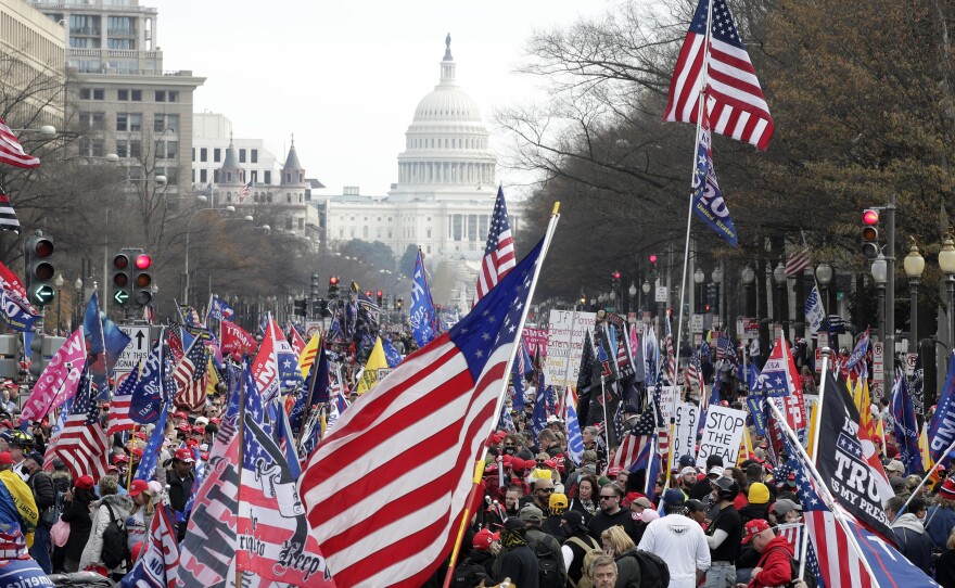 With the U.S. Capitol building in the background, supporters of President Donald Trump stand Pennsylvania Avenue during a rally at Freedom Plaza in Washington D.C., Saturday, Dec. 12, 2020.