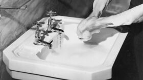Washing hands in a sink in 1937