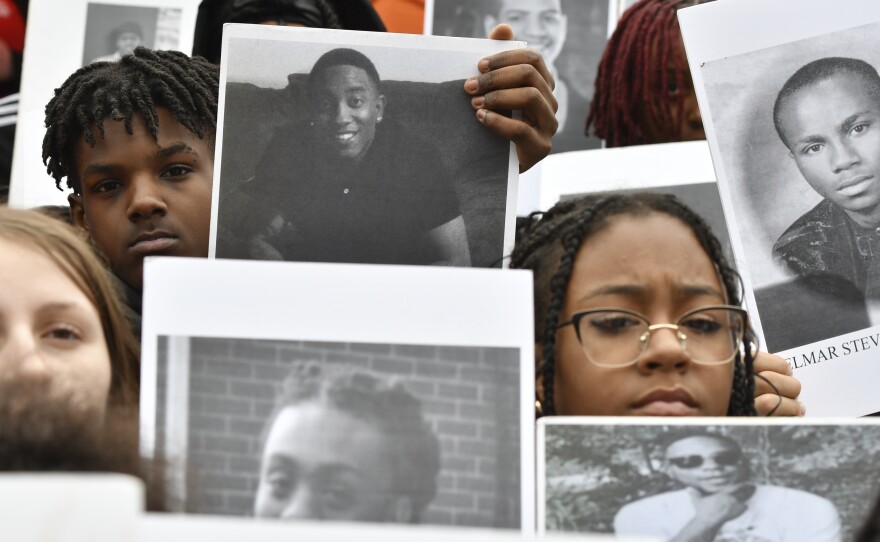 Students from Philadelphia hold photos of gun violence victims at a rally at the Pennsylvania Capitol pressing for stronger gun-control laws, March 23, 2023, in Harrisburg, Pa.